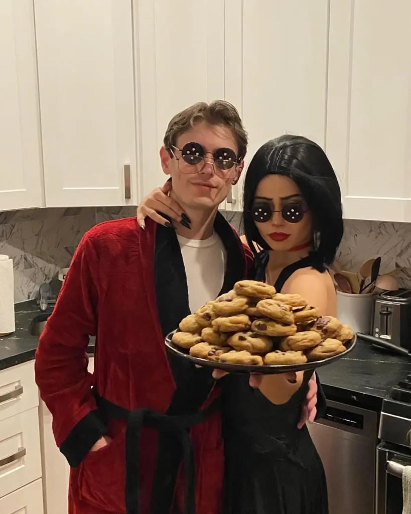 Coraline inspired couple Halloween costume with button glasses and red and black outfits