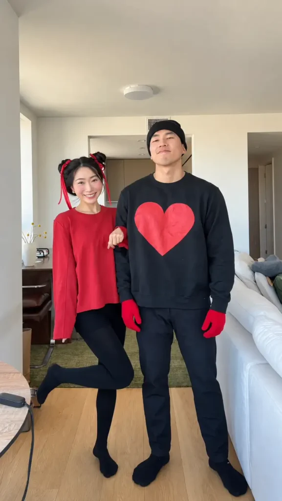 Easy couple Halloween costume with black and red outfits featuring a large red heart theme.