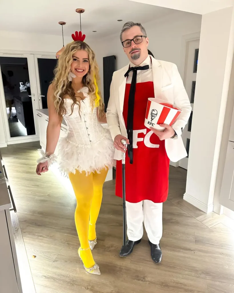 Couple dressed as a chicken and Colonel Sanders with white, yellow, and red costume details.