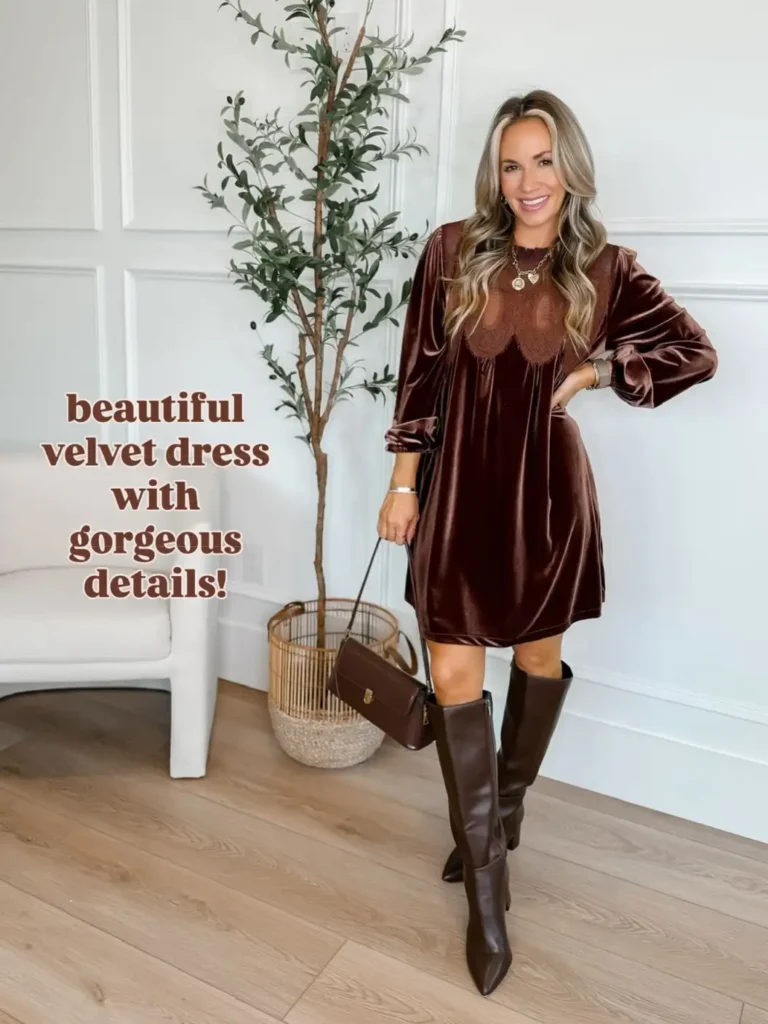 Woman wearing a chocolate brown velvet mini dress with decorative lace neckline details, long sleeves, dark brown knee-high boots, and a matching handbag.