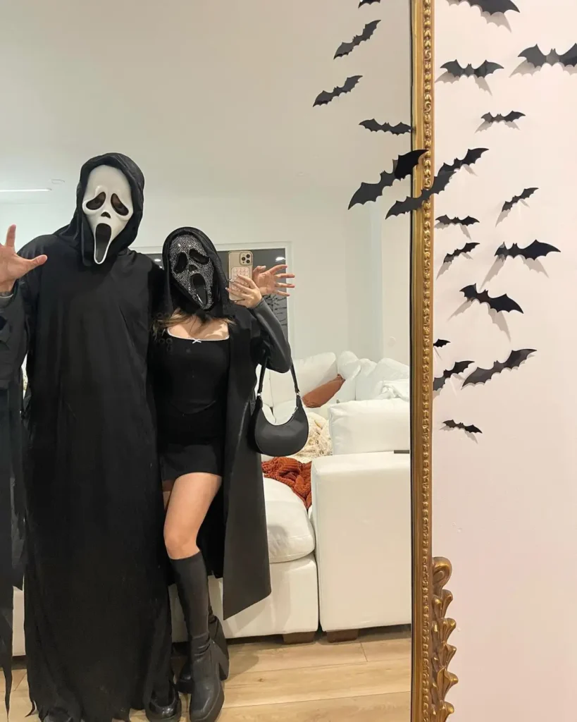 Ghostface couple Halloween costume with matching white masks and all black outfits