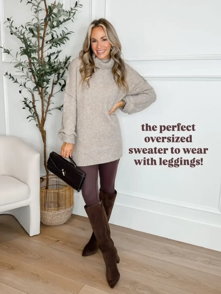 Woman wearing an oversized oatmeal turtleneck sweater with plum brown leggings, chocolate suede knee-high boots, and a black handbag for a cozy Thanksgiving look.