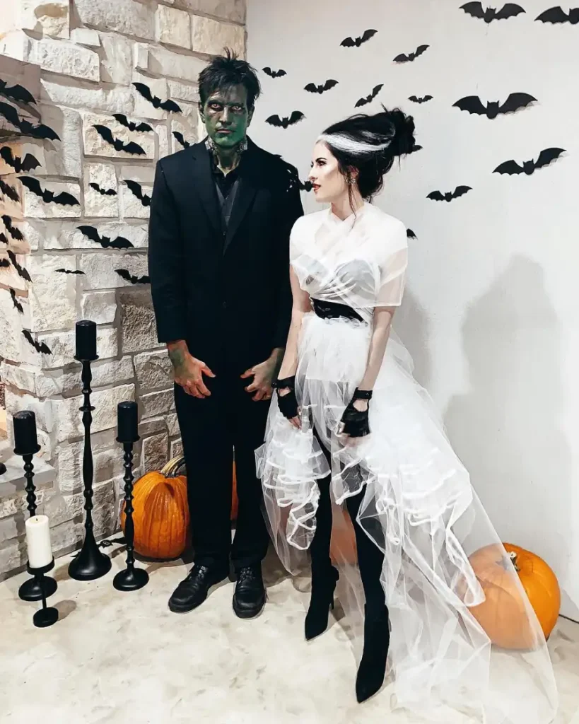 Frankenstein and Bride couple Halloween costume with green makeup, black suit and white dress