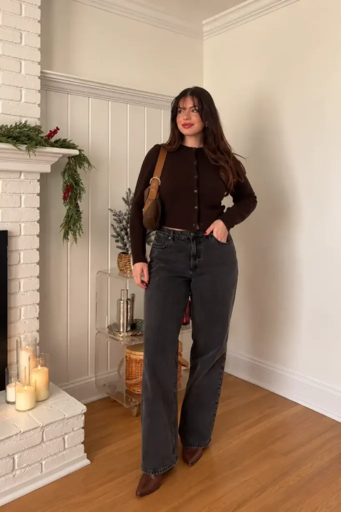 Woman wearing a chocolate brown button-front cardigan with charcoal gray wide-leg jeans, brown pointed boots, and a tan shoulder bag for a casual fall look.