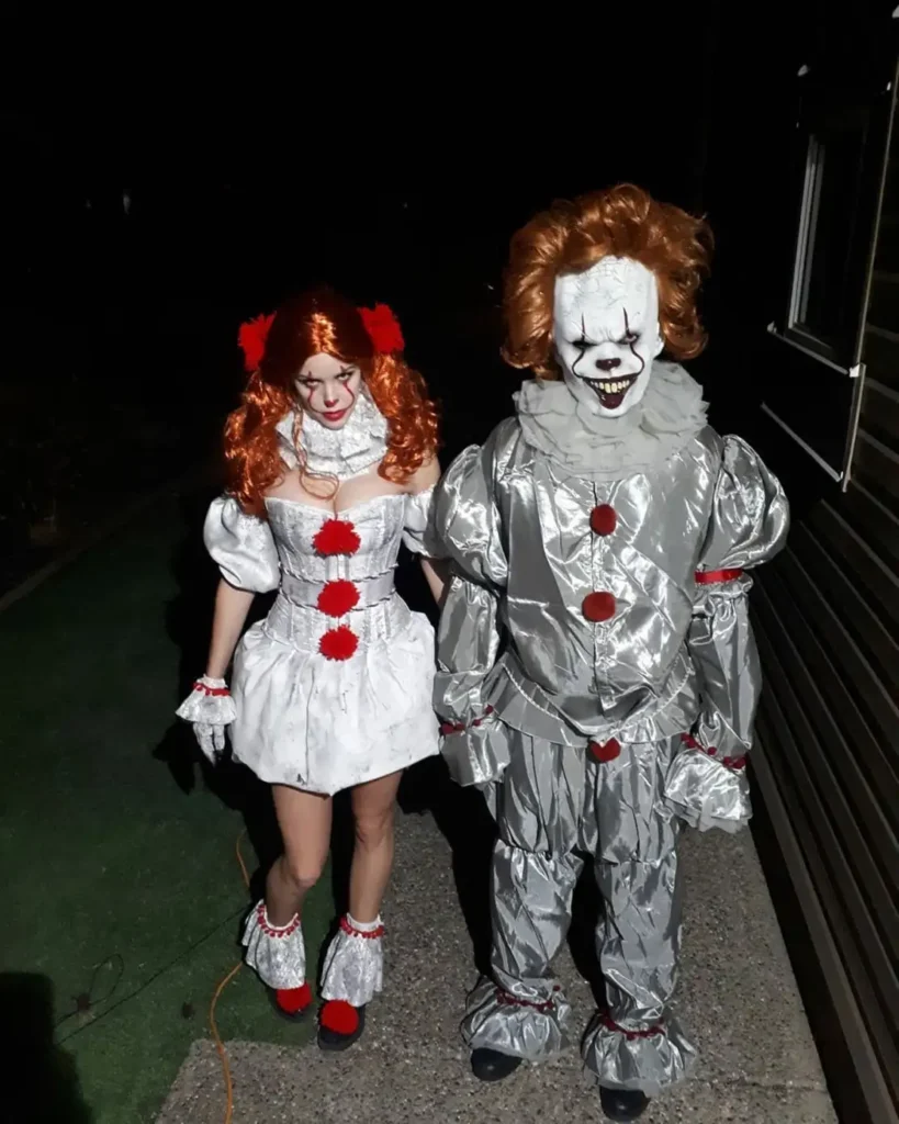 IT clown couple Halloween costume with Pennywise makeup, orange wigs and silver outfits