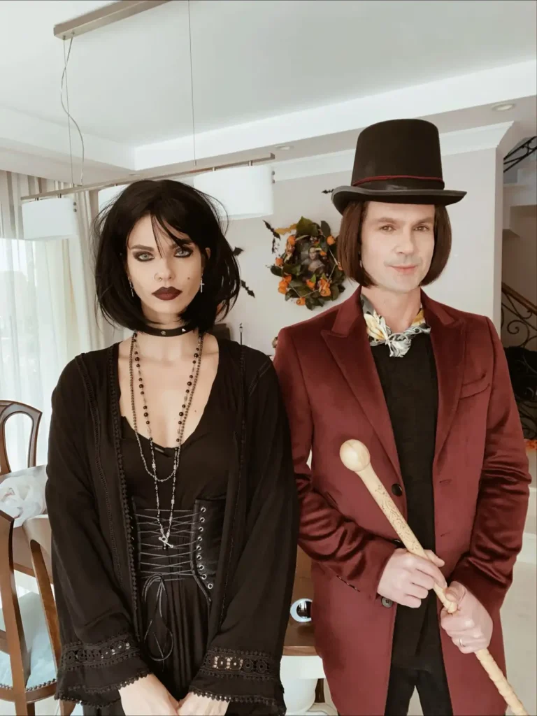 Spooky couple Halloween costumes featuring a black gothic outfit beside a burgundy blazer, black top hat, and vintage accessories.